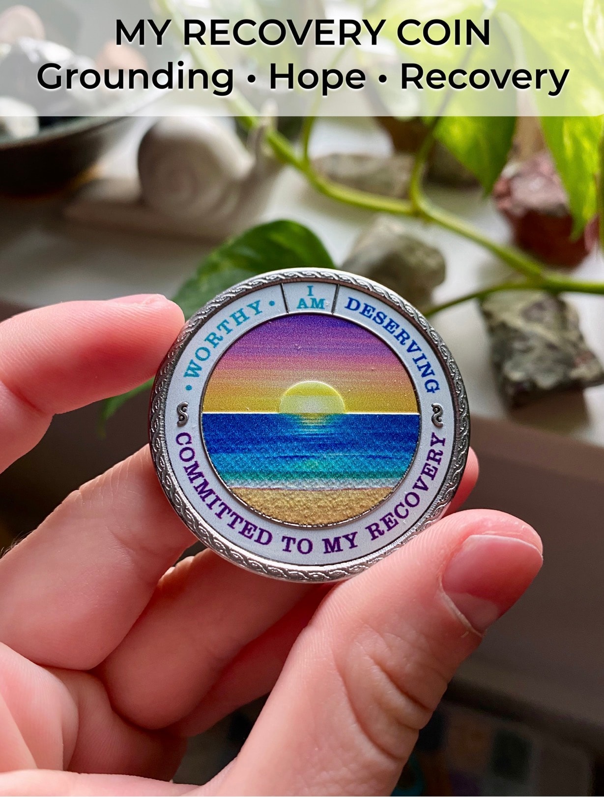 My Recovery Coin held in hand, showing its Beach Sunset design and pocket-sized scale